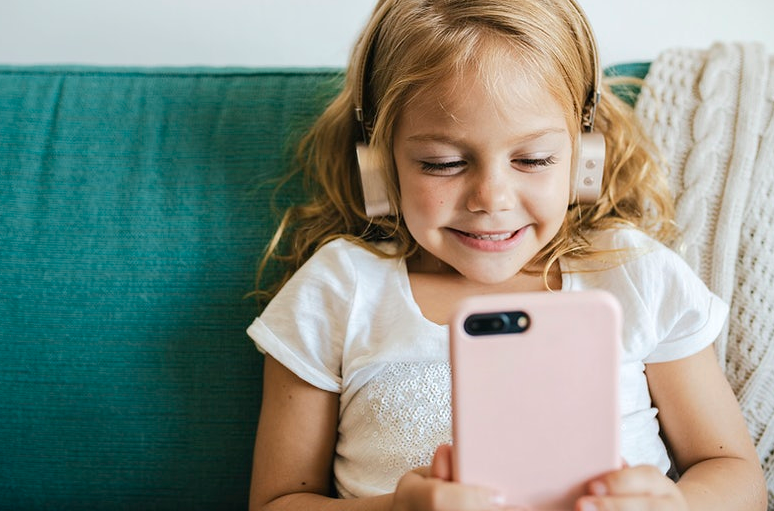kid using phone with headset